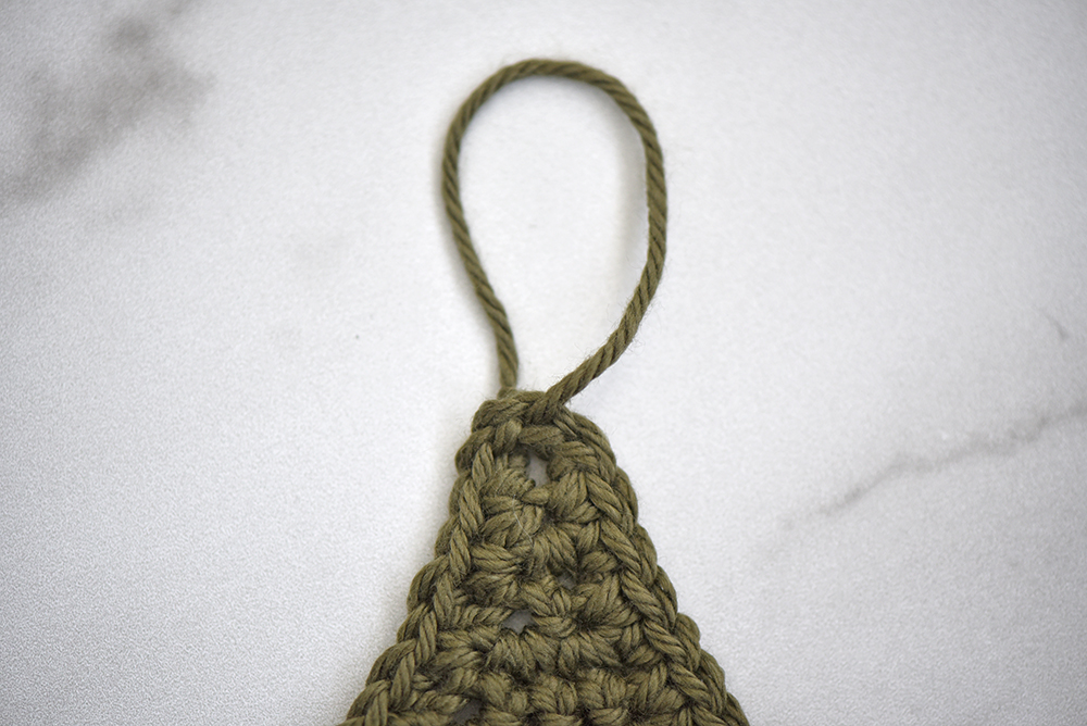 Photo shows a hanging loop on a crochet tree.