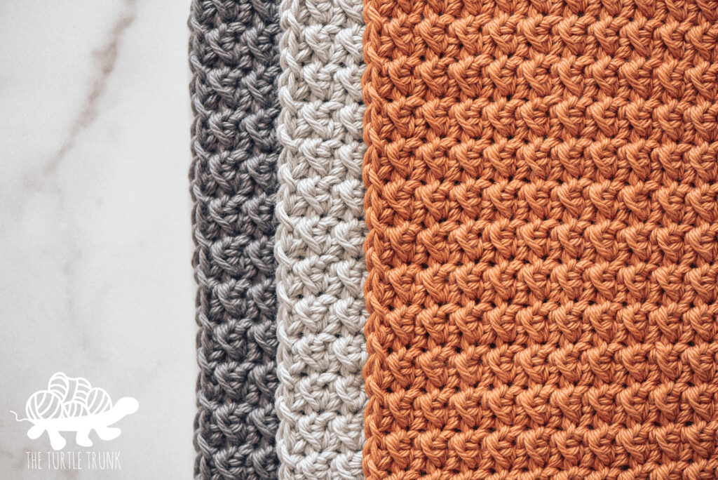 Photo shows 3 crochet dish cloths laying on a white surface. Crochet pattern is the Farmhouse Dish Set by The Turtle Trunk.