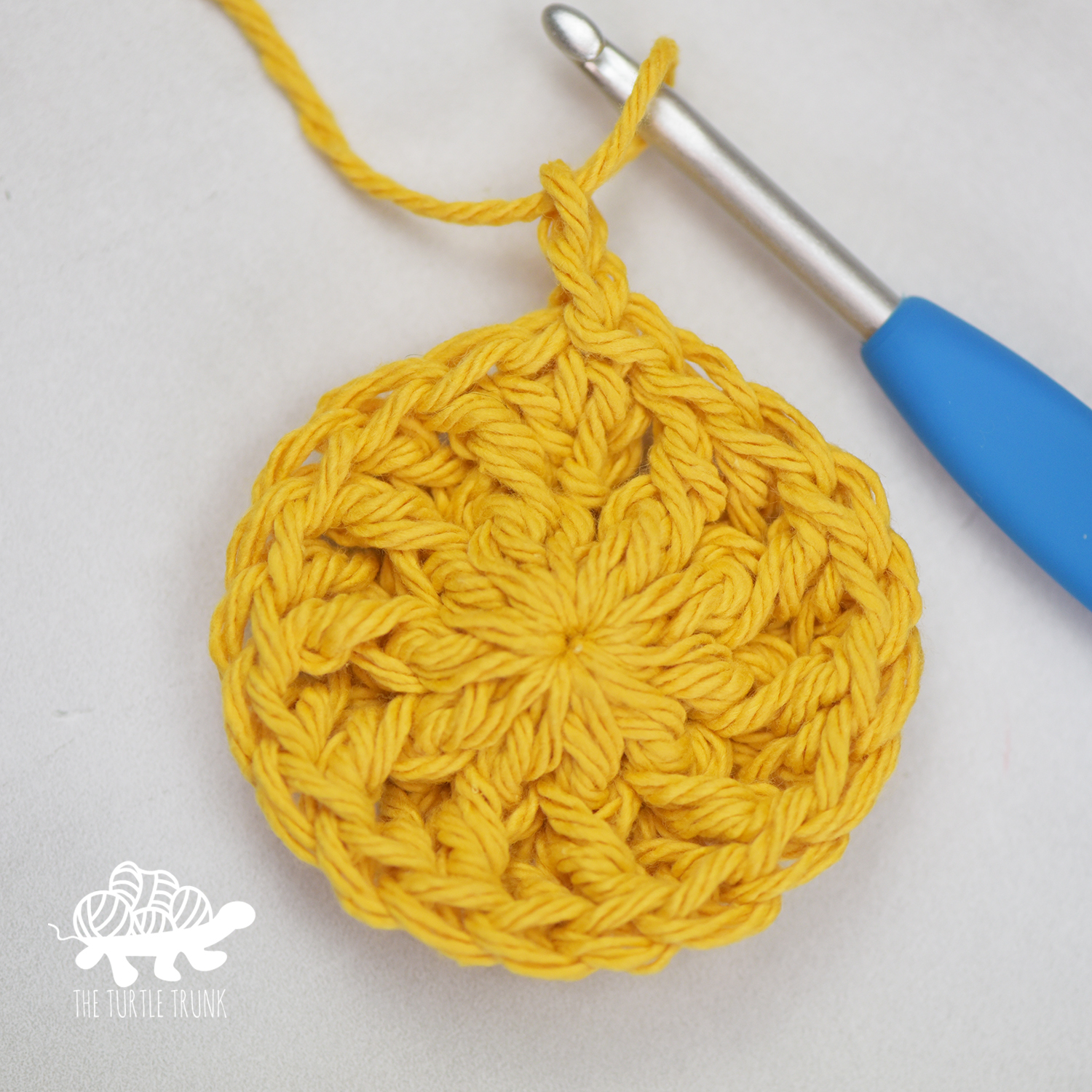 Rounds 1 and 2 of the Hello Sunshine Placemat crochet pattern by The Turtle Trunk.