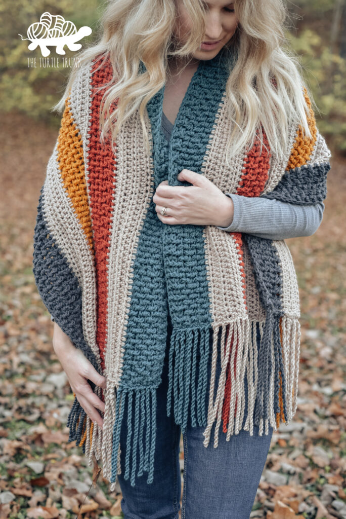 Woman wearing a striped crochet scarf.