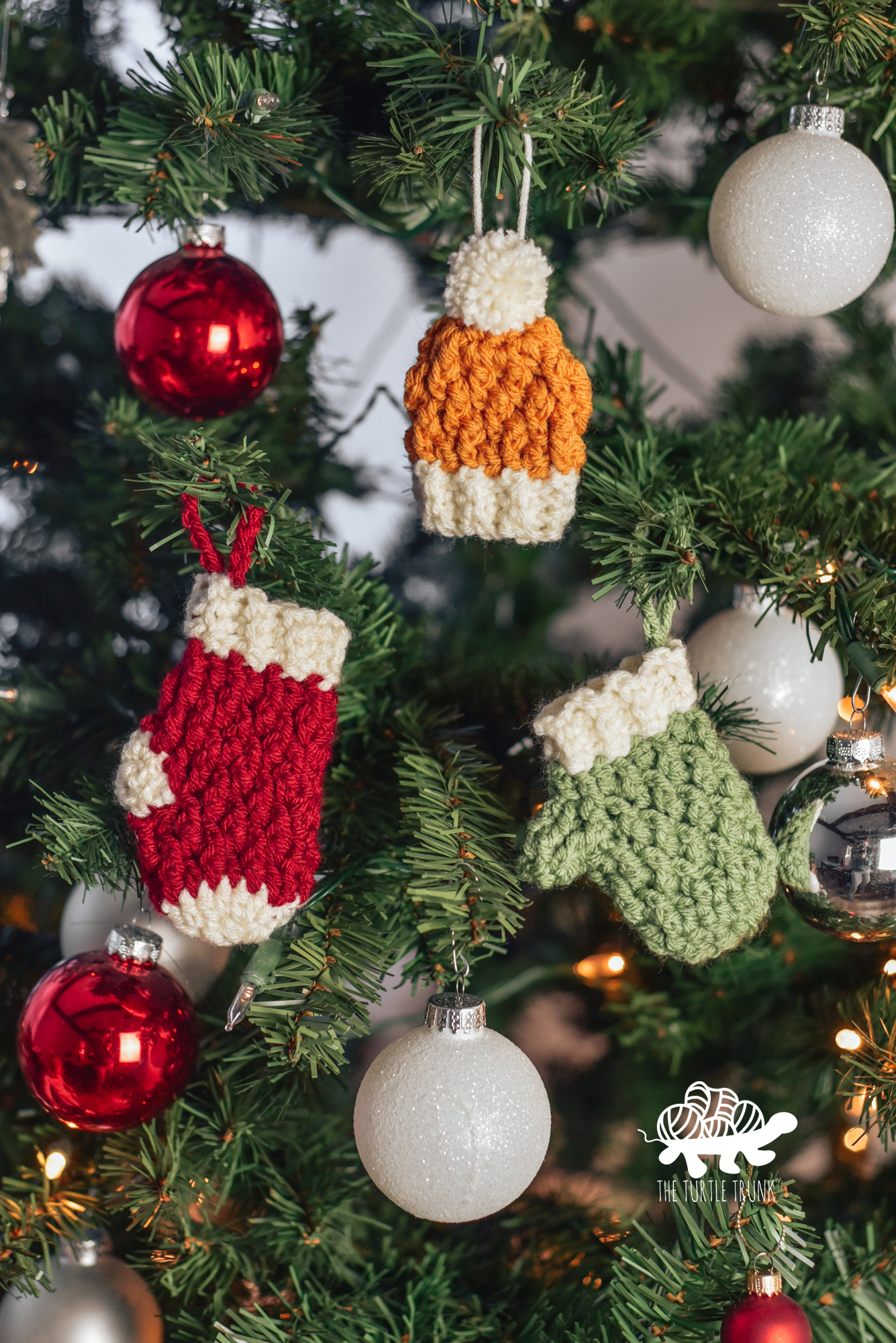 Photo shows a Christmas tree with the Country Cottage Minis crochet patterns by The Turtle Trunk hanging on it.