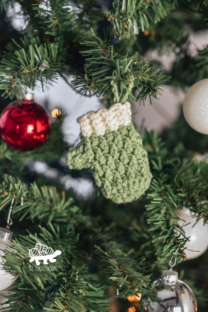 Photo of a mini crochet mitten gift card holding and tree ornament.