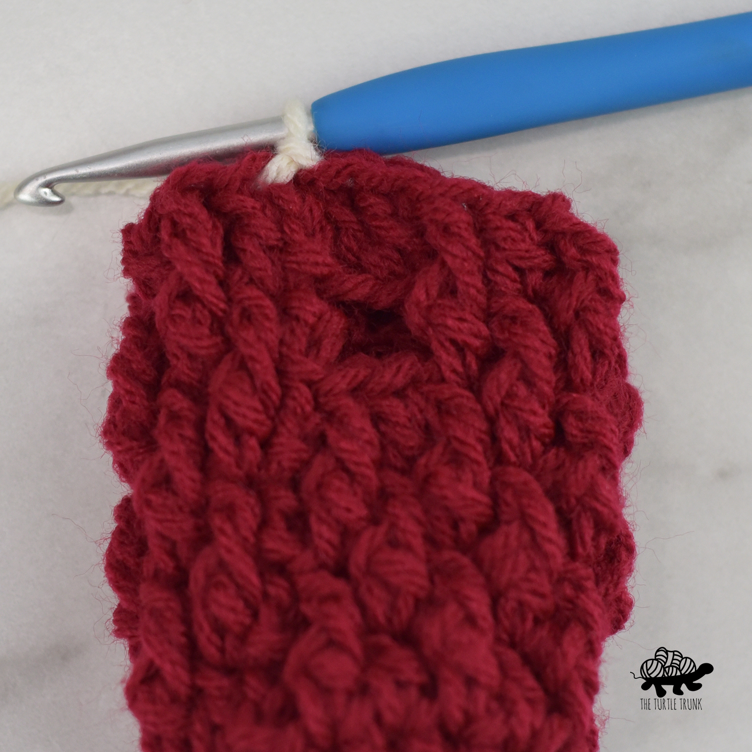 Photo shows changing colors for the cuff on the Mini Country Cottage Mitten crochet pattern by The Turtle Trunk.