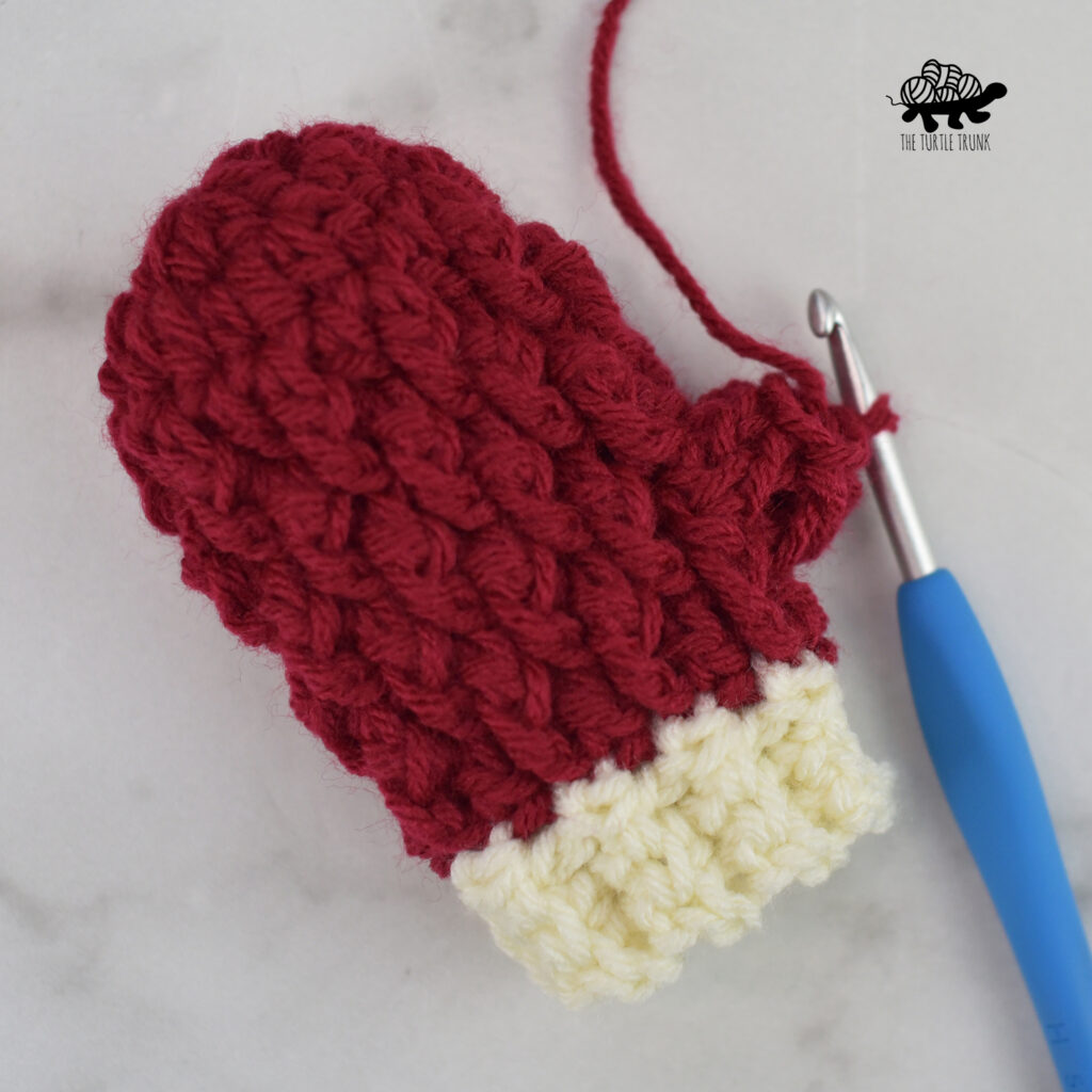 Adding the thumb to the Mini Country Cottage Mitten crochet pattern by The Turtle Trunk.