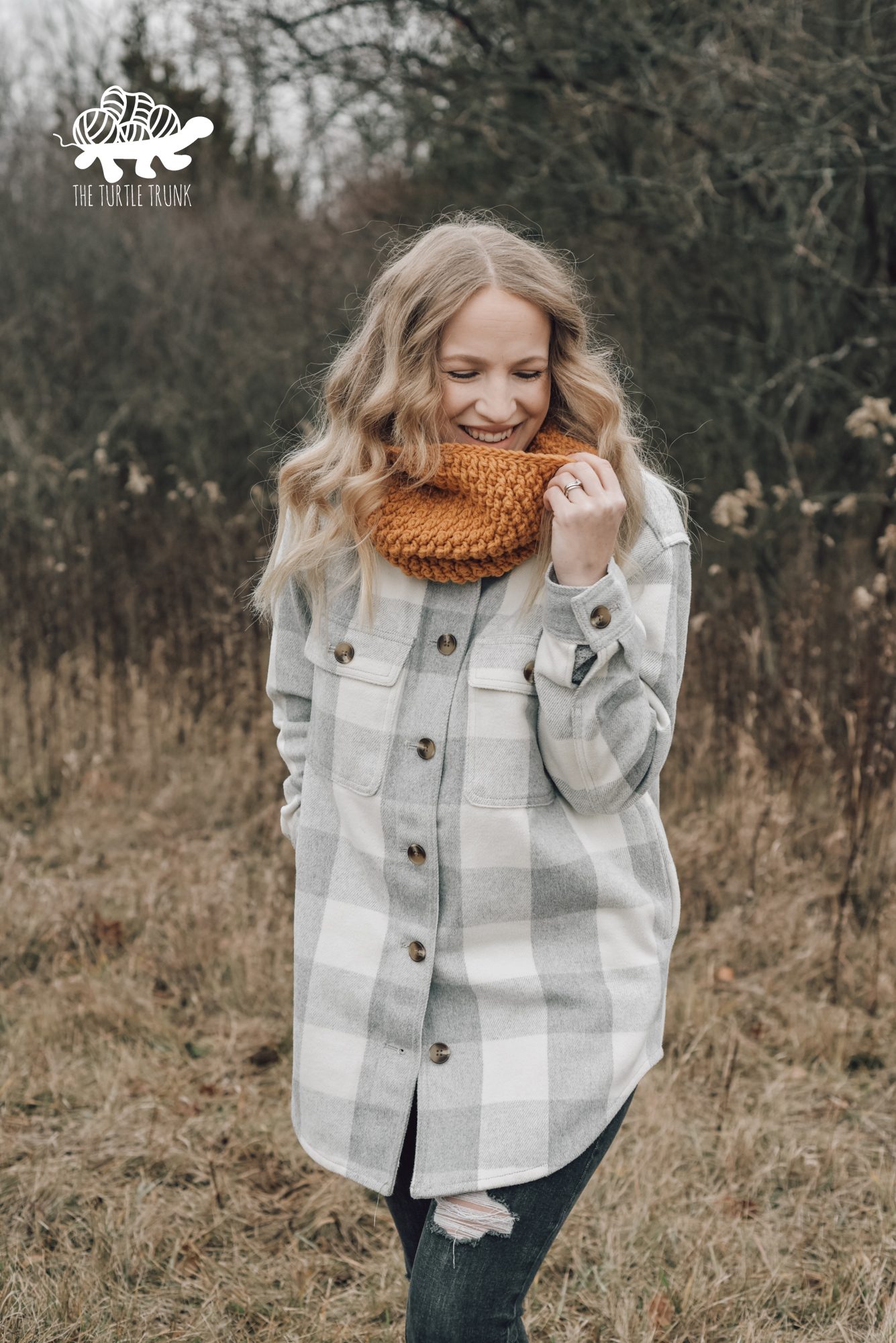 Photo shows a woman wearing a yellow, crochet cowl. Crochet pattern is the Country Cottage Cowl by The Turtle Trunk.