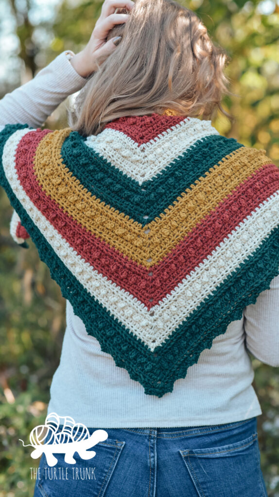 Photos show a woman wearing a striped, crochet, triangle scarf.