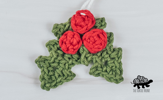 A crochet holly applique.