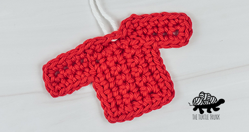 A crochet sweater applique.