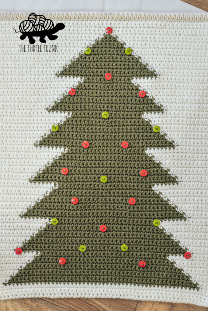 Photo shows a crochet Tree Wall Hanging with 25 buttons sewn on it.