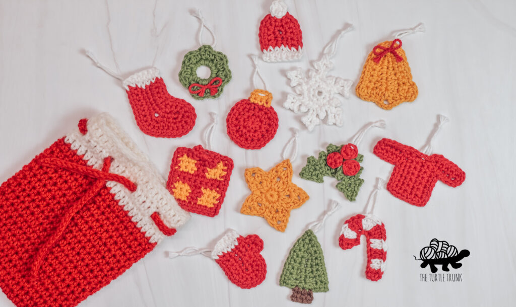 Photo shows 13 Christmas crochet appliqués laying on a white surface.