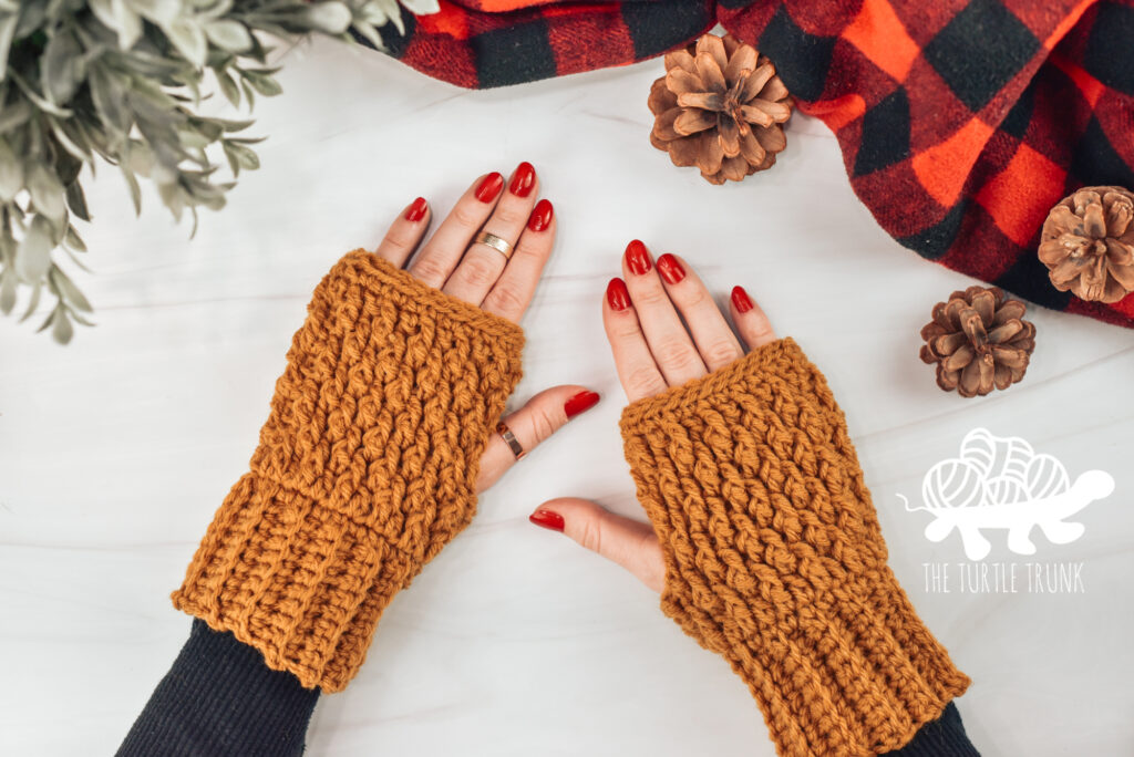 Photo shows 2 hands wearing crochet fingerless gloves.