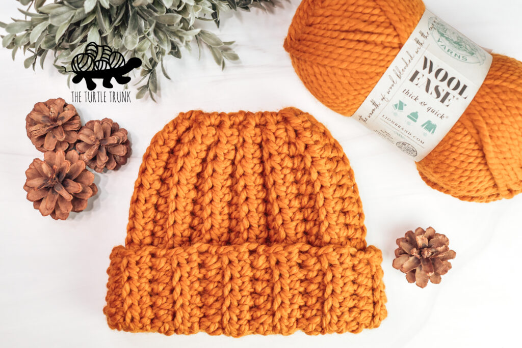 Photo shows a skein of Lion Brand Yarns Wool Ease Thick and Quick in the color Butterscotch and a matching crochet beanie.