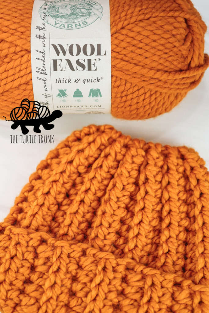 Photo shows a skein of Lion Brand Yarns Wool Ease Thick and Quick in the color Butterscotch and a matching crochet beanie.