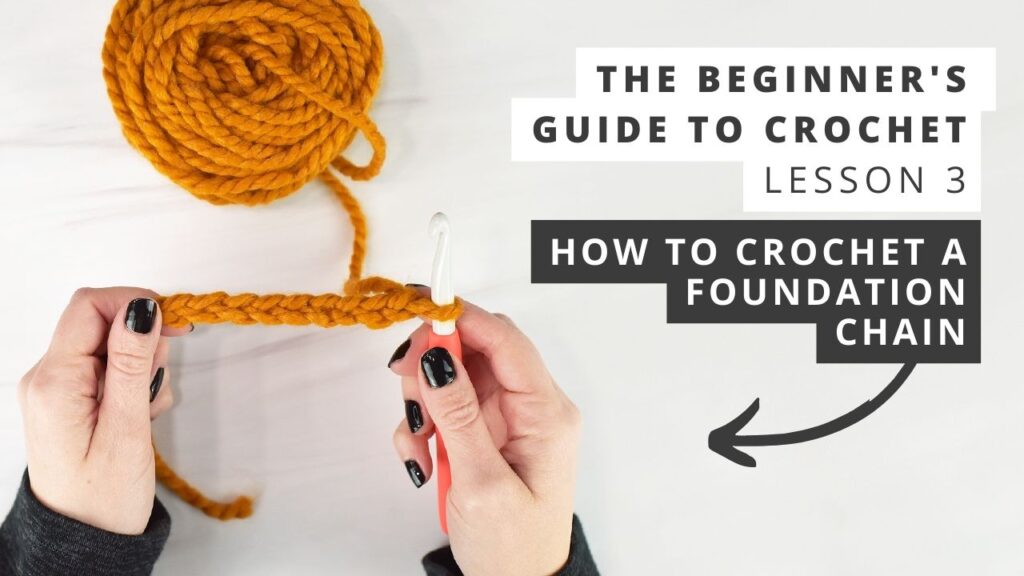 How to crochet a foundation chain. Photo shows hands holding yarn, a crochet hook, and a foundation chain.