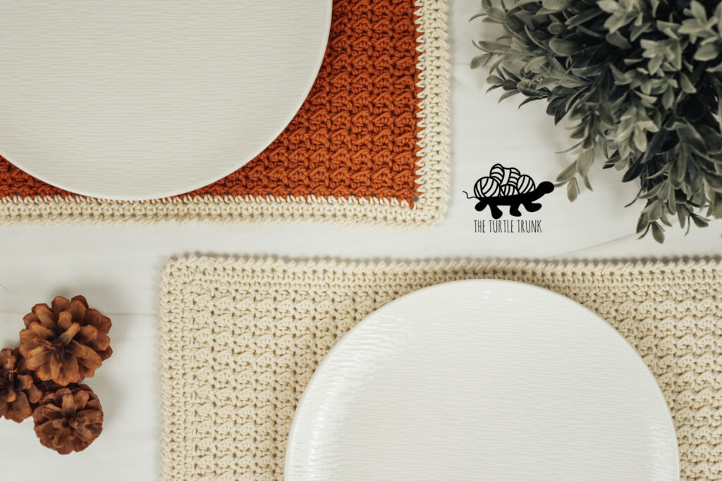 2 crochet placemats with white plates sitting on top of them.