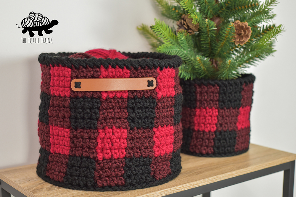 2 crochet buffalo plaid baskets on a shelf.