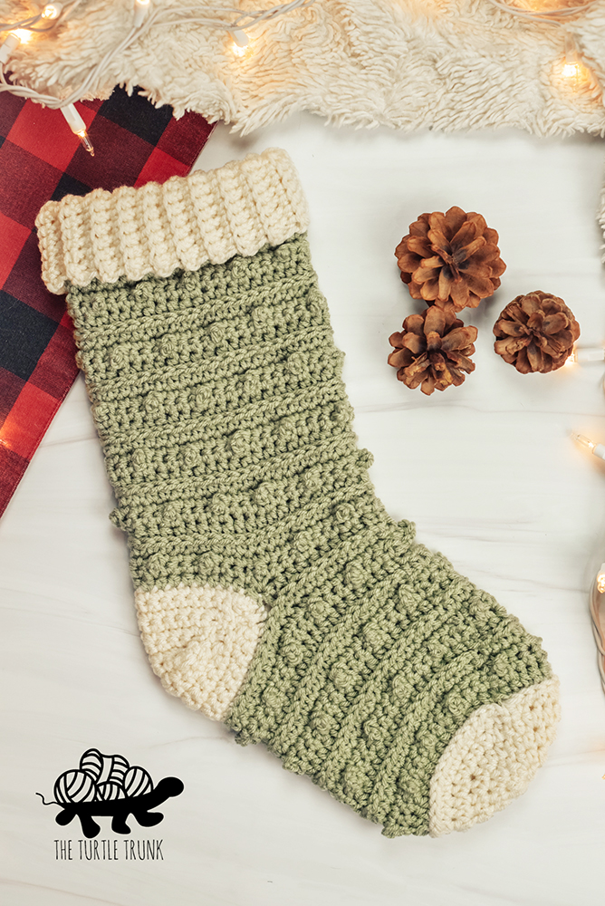 A green and white crochet stocking.