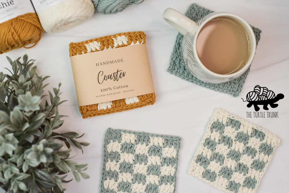 Photo shows crochet coasters and a paper label wrapped around 1.
