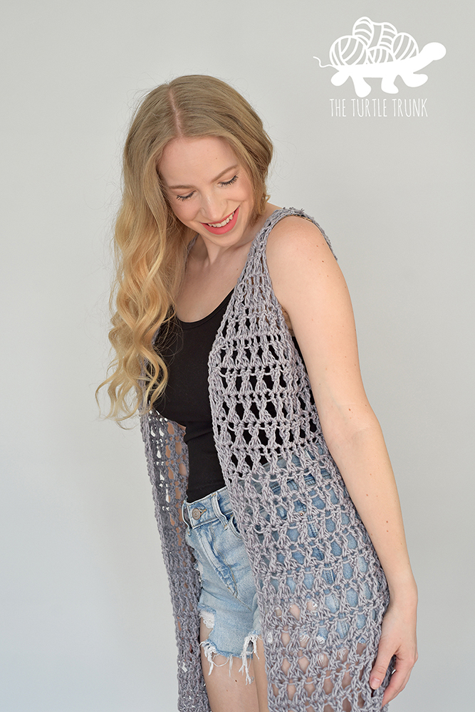 Woman wearing a crochet vest (Crossroads Vest by The Turtle Trunk).