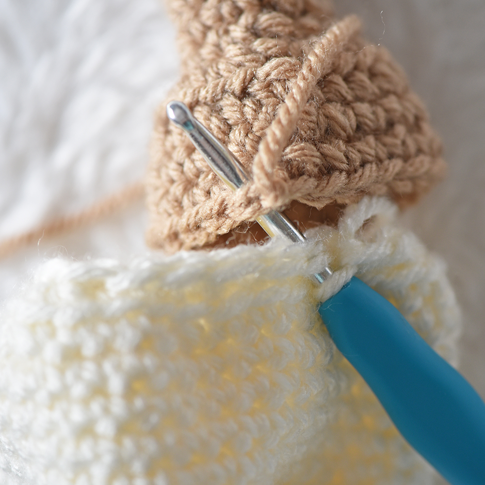 Close up of attaching amigurumi ice cream and cone.