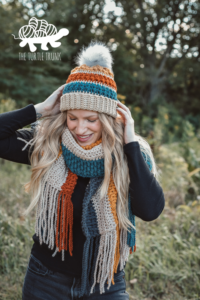 Woman wearing a matching crochet beanie and scarf. Patterns are the Bonfire Beanie and Bonfire Scarf by The Turtle Trunk.