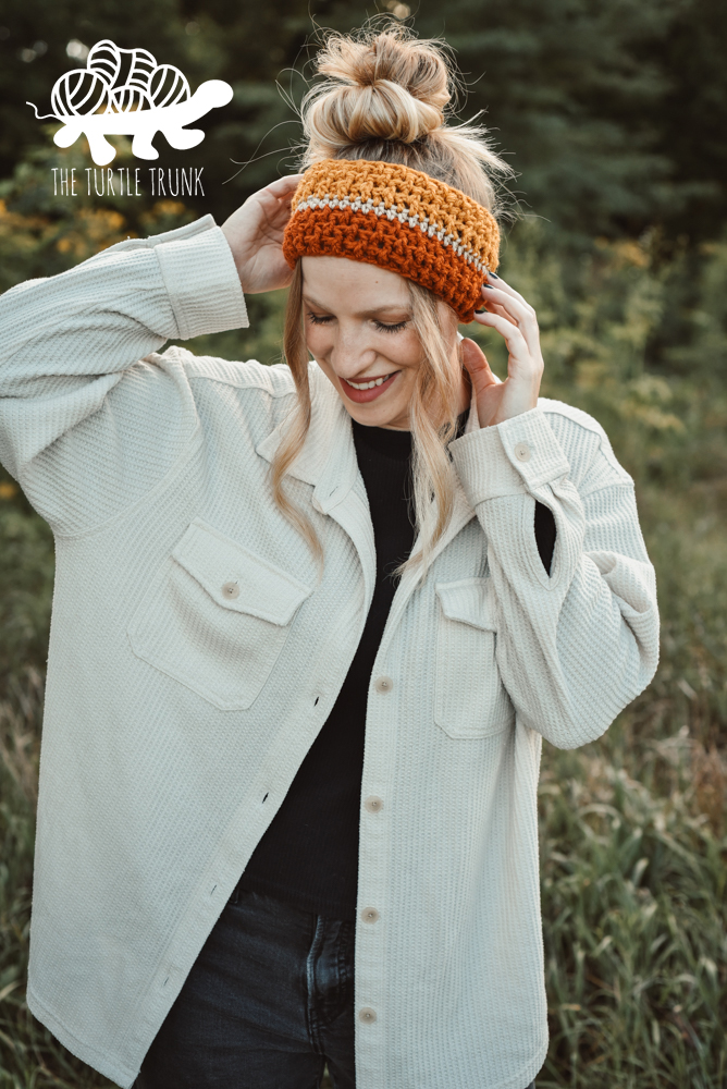 Woman wearing a striped, crochet headband.